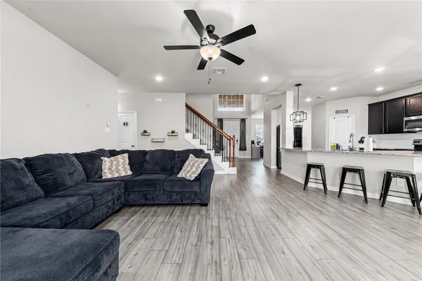 a living room with furniture and wooden floor