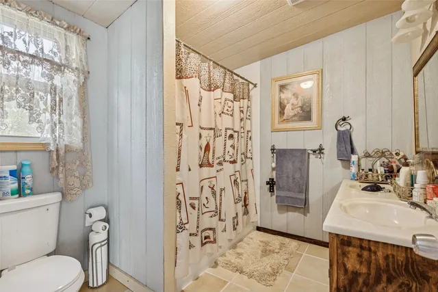 a bathroom with a sink vanity and a mirror