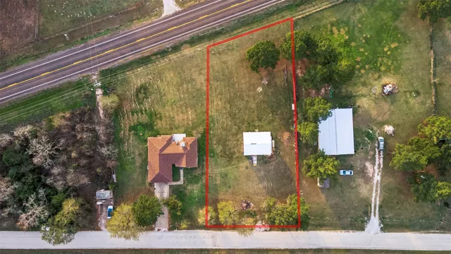 an aerial view of a house with a yard