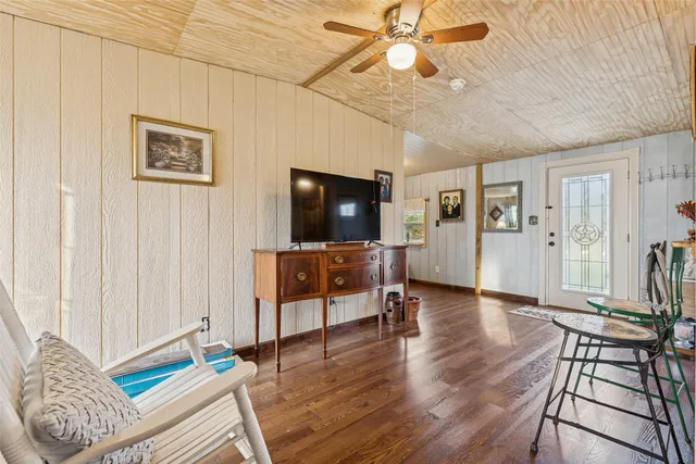 a living room with furniture a wooden floor and a fireplace