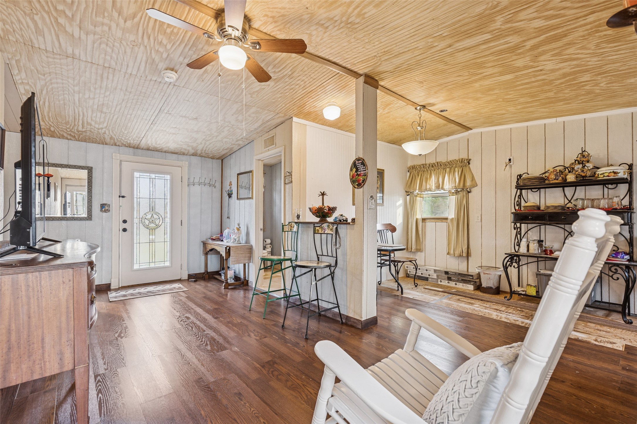 25 Pine Prairie School Road Huntsville, TX 77320 - Photo 6 of 15 a living room with furniture a wooden floor and a fireplace