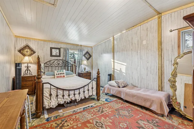 a bedroom with bed and a closet