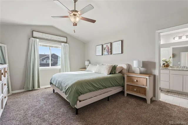 a spacious bedroom with a bed and a window