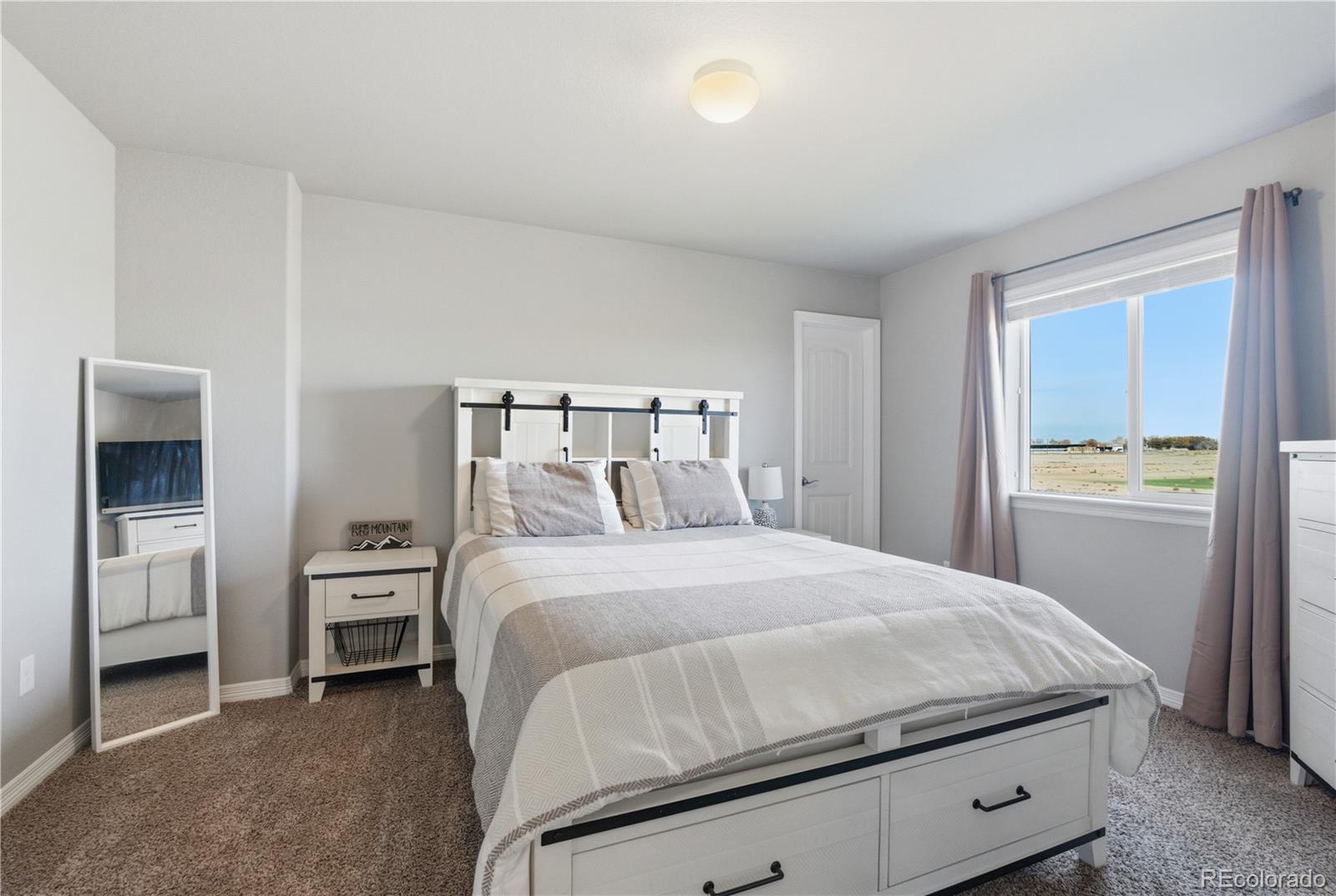 2173 Angus Street Mead, CO 80542 - Photo 18 of 28 a bedroom with a bed and a view of kitchen