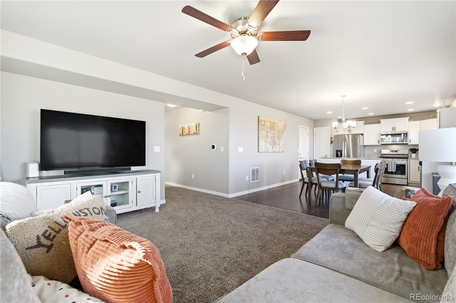 2173 Angus Street Mead, CO 80542 - Photo 5 of 28 a living room with furniture and a flat screen tv