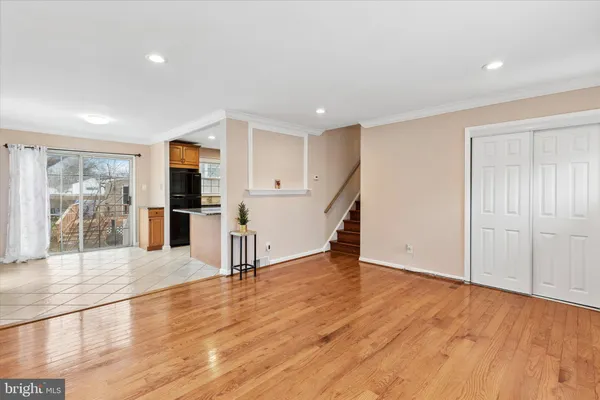 a view of empty room with wooden floor and floor to ceiling window