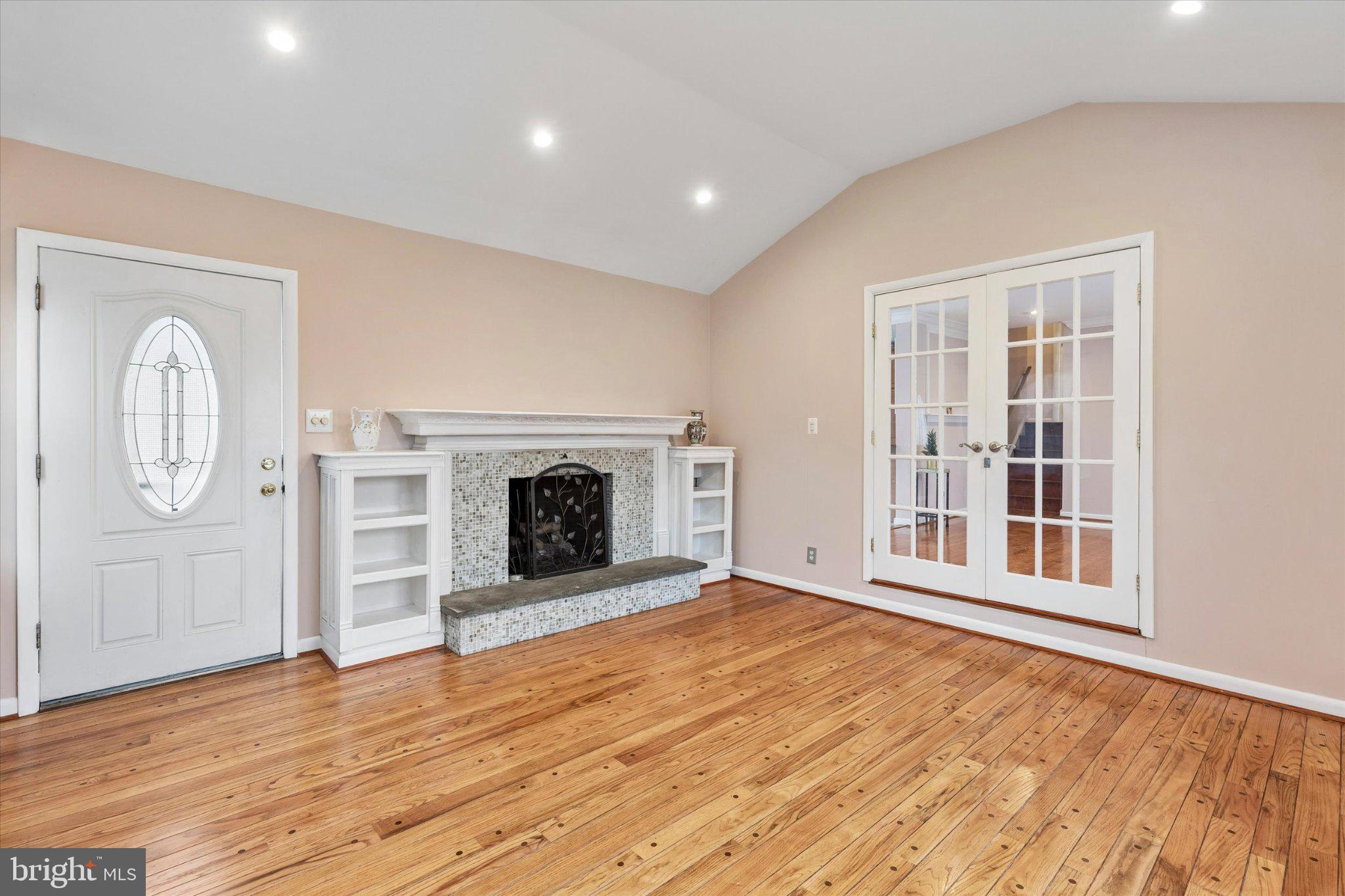 4150 Orangemans Road Hatboro, PA 19040 - Photo 7 of 25 a view of an empty room with wooden floor fireplace and a window