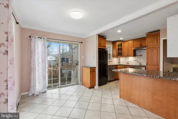 a kitchen with a refrigerator a oven and a sink