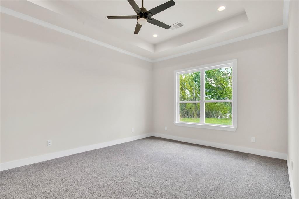 1028 Henry Way Springtown, TX 76082 - Photo 15 of 40 an empty room with a window and a fan