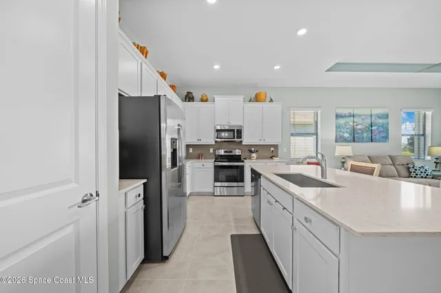 a living room with kitchen island furniture and a rug