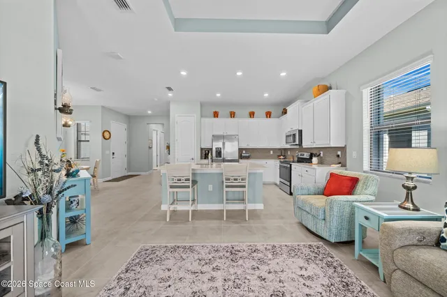 a spacious bedroom with a bed and a chandelier