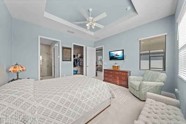 a bedroom with a large bed and a window