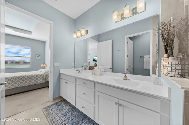 a bathroom with a double vanity sink a shower and a mirror