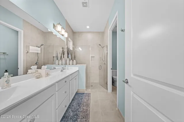 a view of walk in closet with clothes