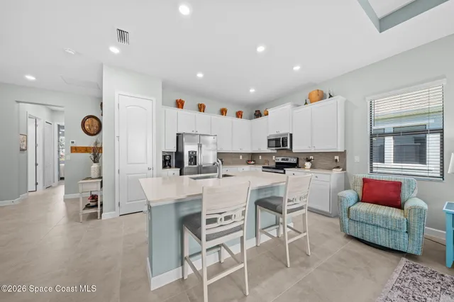 a kitchen with stainless steel appliances kitchen island granite countertop a sink and cabinets