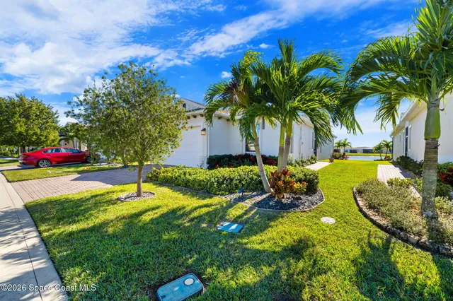 a aerial view of a house with swimming pool and a yard