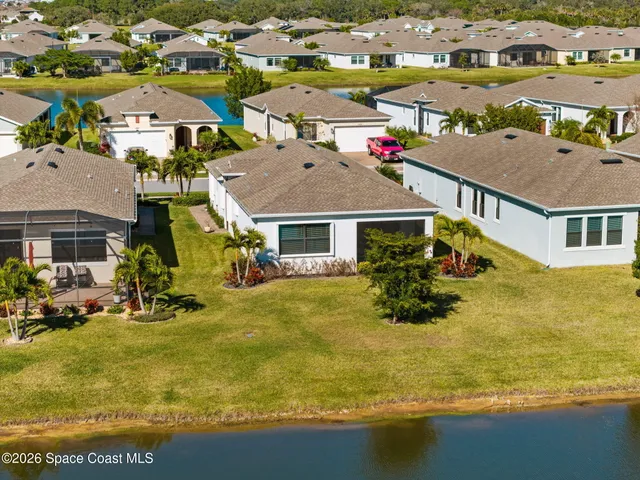 an aerial view of house with a yard