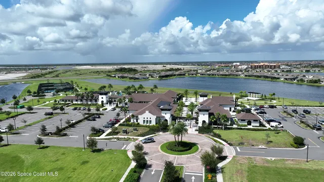 a view of a dining hall with furniture and a large window