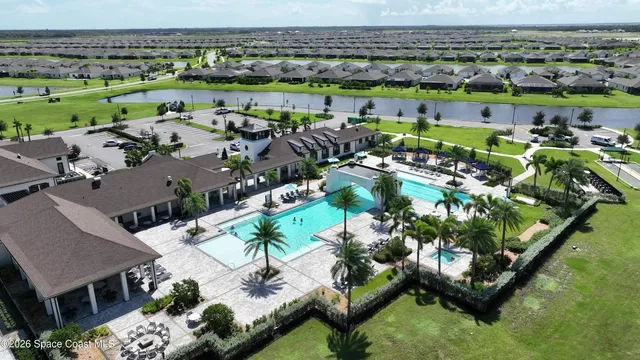 a swimming pool with outdoor seating and yard