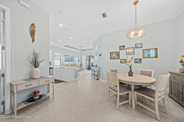 a view of a dining room with furniture and a chandelier