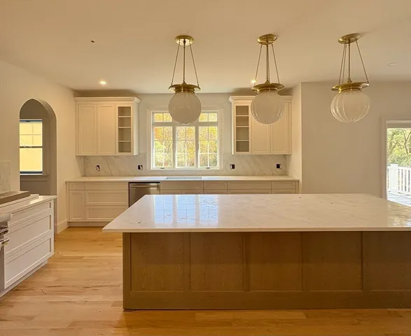 a view of a room with wooden floor and windows