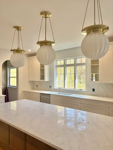 a kitchen with a sink a window and cabinets