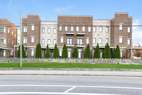 a front view of a building with a yard