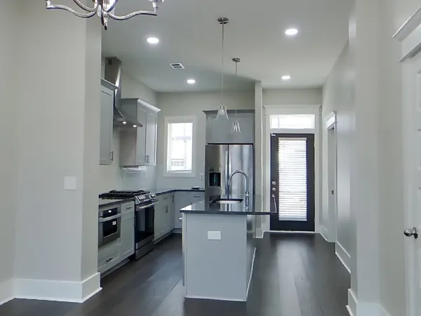 a view of a kitchen with a sink and a refrigerator
