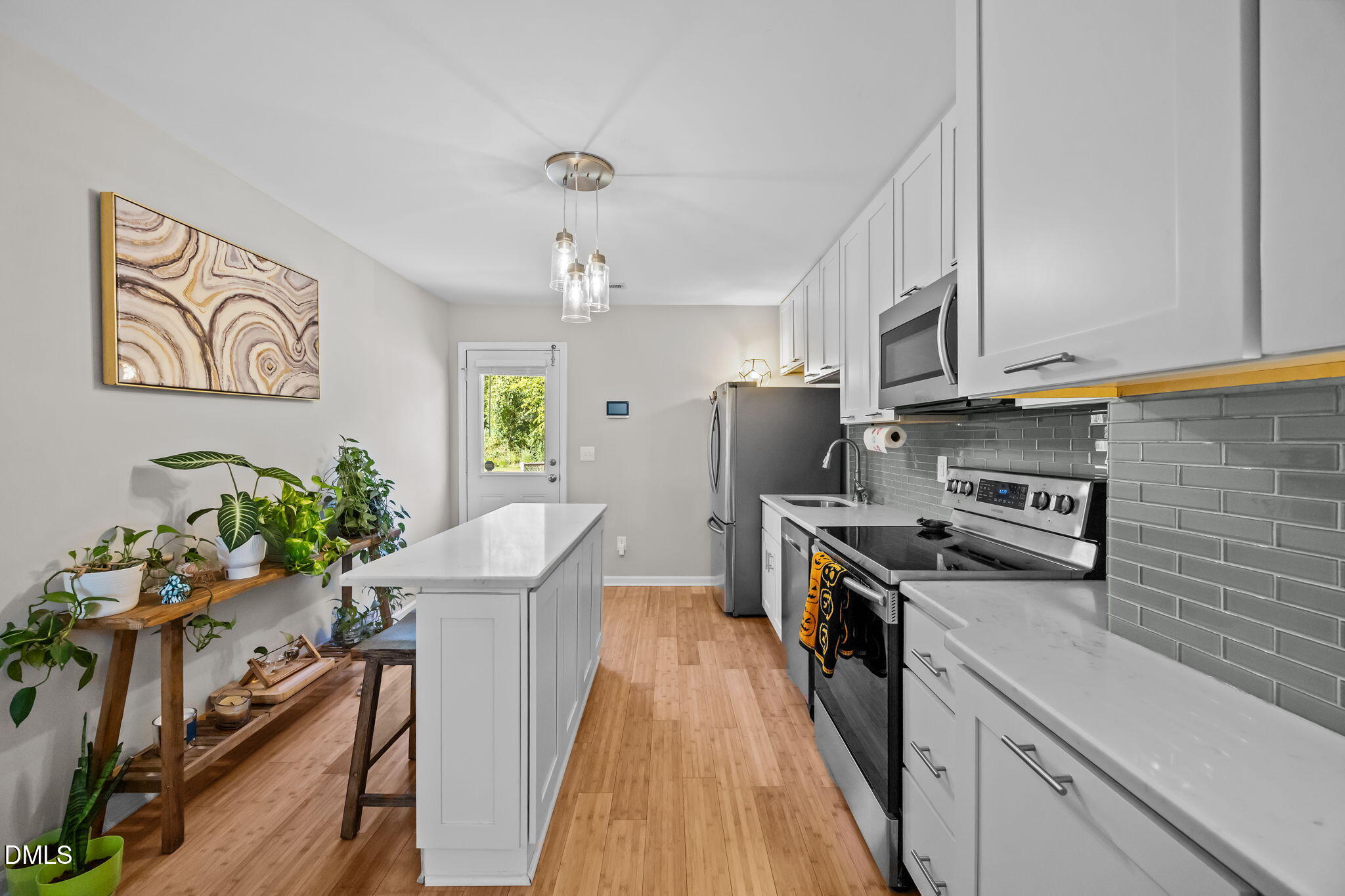 1316 South State Street, Unit D Raleigh, NC 27610 - Photo 11 of 36 a kitchen with stainless steel appliances a stove refrigerator sink and microwave