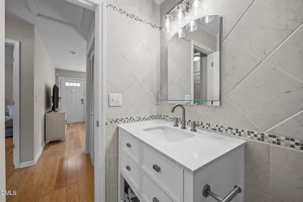 a bathroom with a sink a mirror and a shower