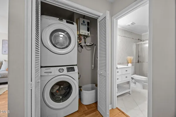 a view of a bathroom with washing machine and racks