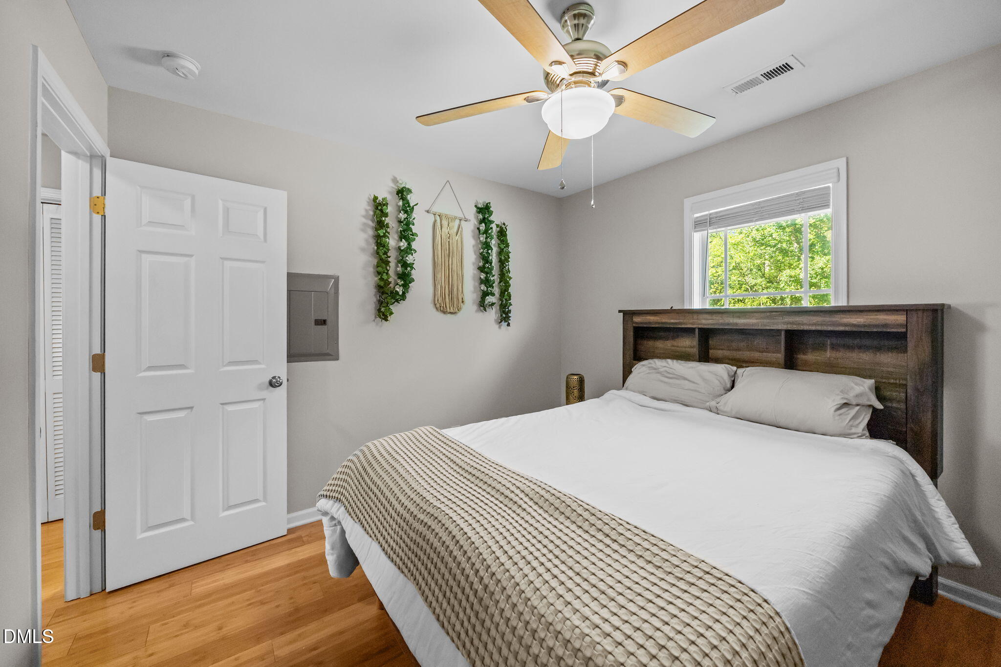 1316 South State Street, Unit D Raleigh, NC 27610 - Photo 17 of 36 a bedroom with a large bed and a chandelier