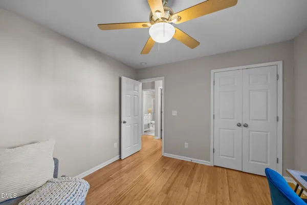 a view of room with wooden floor and fan