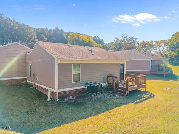a aerial view of a house with a yard and deck