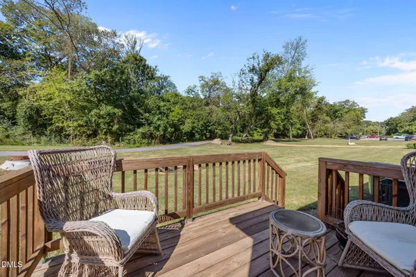 a view of a chair and table on the deck