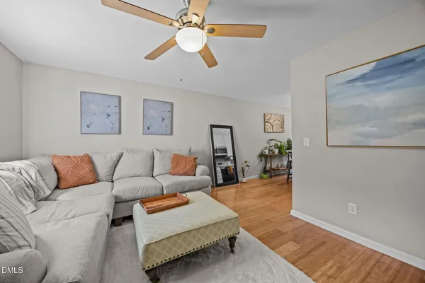 a living room with furniture and a wooden floor
