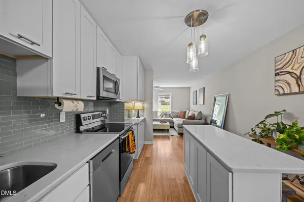 a kitchen with stove a sink and refrigerator