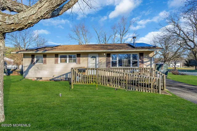 a view of a house with a yard and sitting area