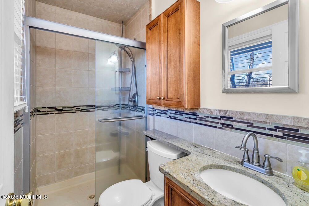 2 Drew Court Jackson, NJ 08527 - Photo 17 of 26 a bathroom with a granite countertop sink toilet and shower