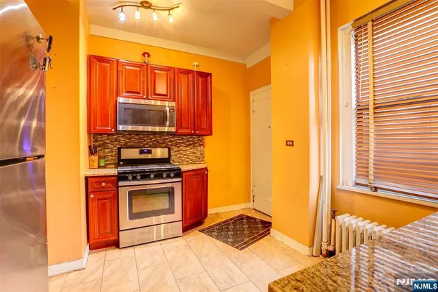 a view of a workspace with wooden floor and a window