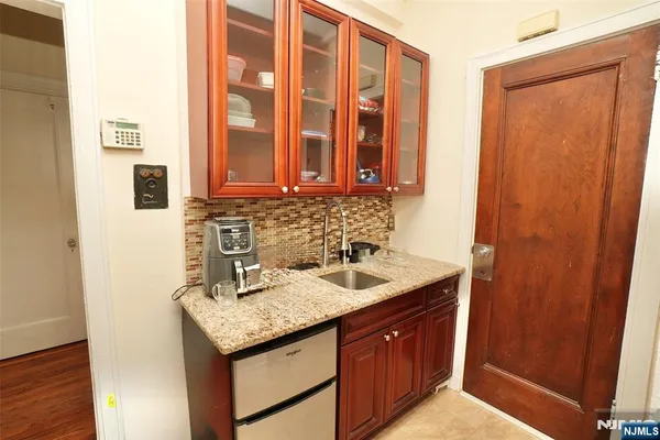 a kitchen with granite countertop cabinets and utility room