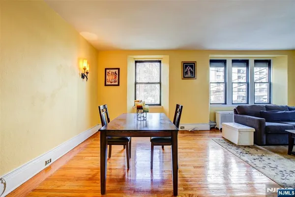 a view of a workspace with wooden floor and a window