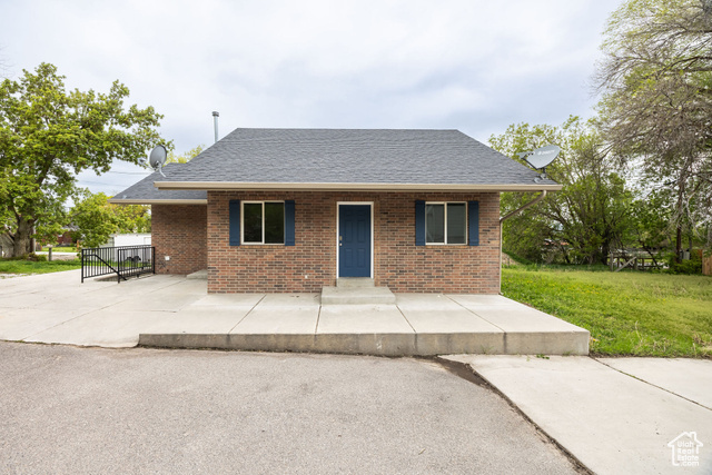 Undisclosed Address Logan, UT 84321 - Photo 1 of 1 Single story home featuring roof with shingles, a front lawn, and brick siding
