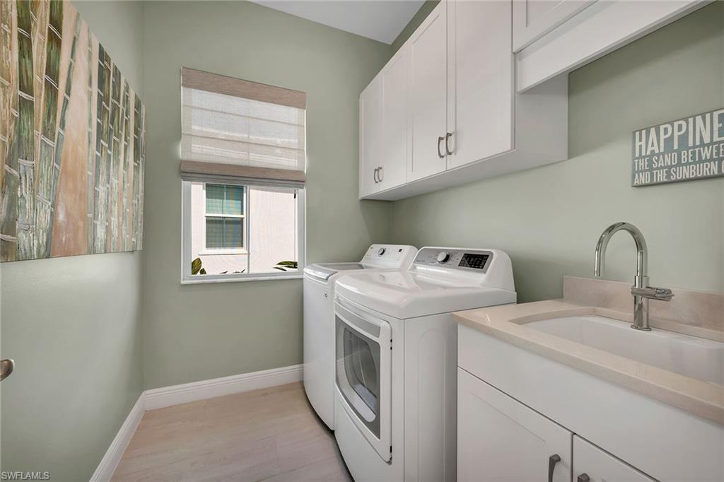 9020 Mayreau Way Naples, FL 34114 - Photo 11 of 28 a utility room with dryer and washer