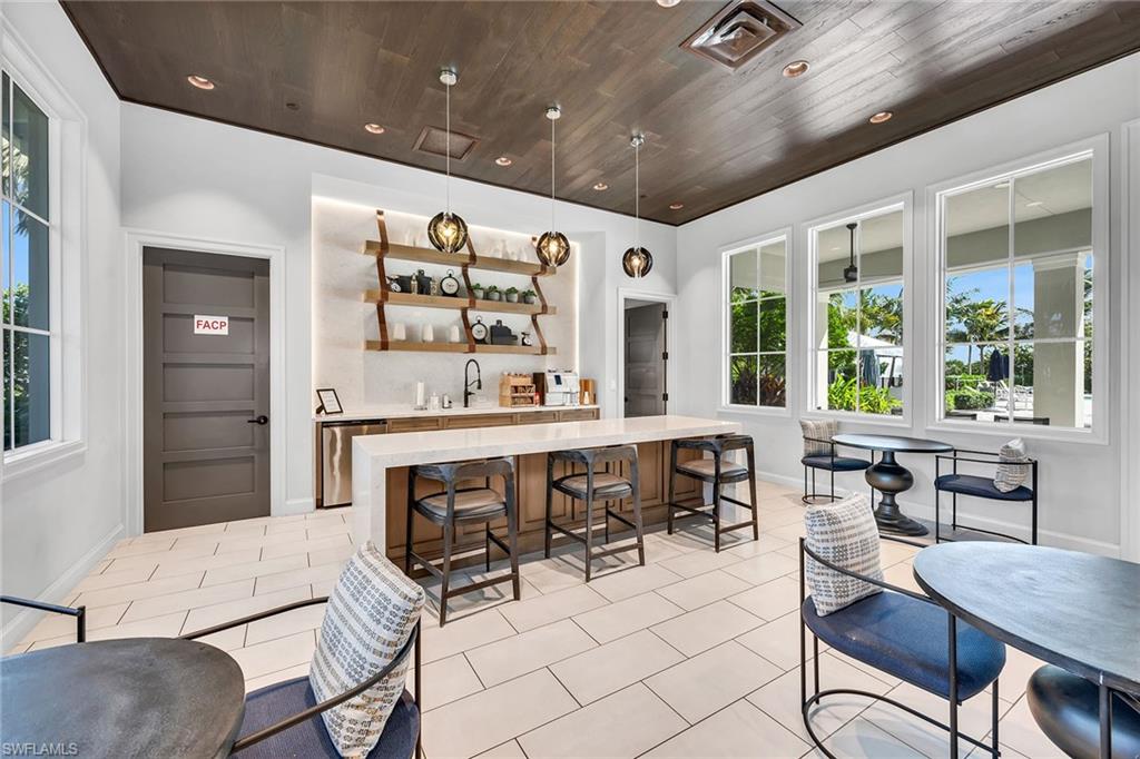 9020 Mayreau Way Naples, FL 34114 - Photo 18 of 28 a kitchen with a table chairs and a dining table