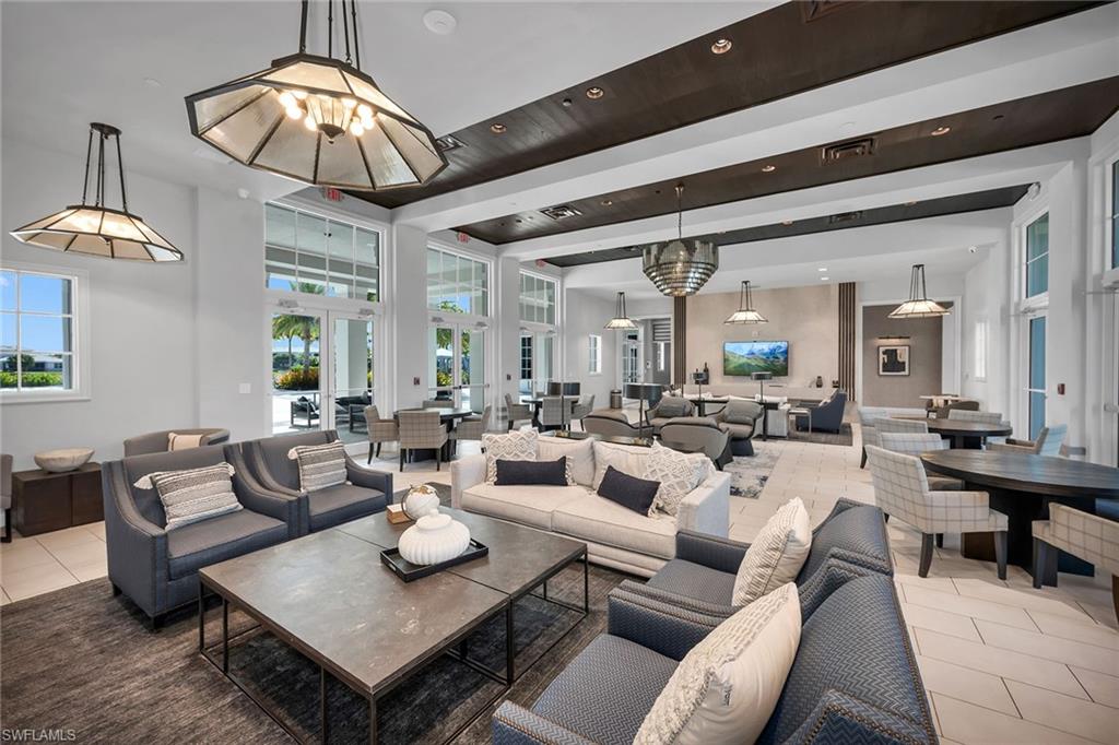 9020 Mayreau Way Naples, FL 34114 - Photo 21 of 28 a living room with lots of furniture and view of chandelier