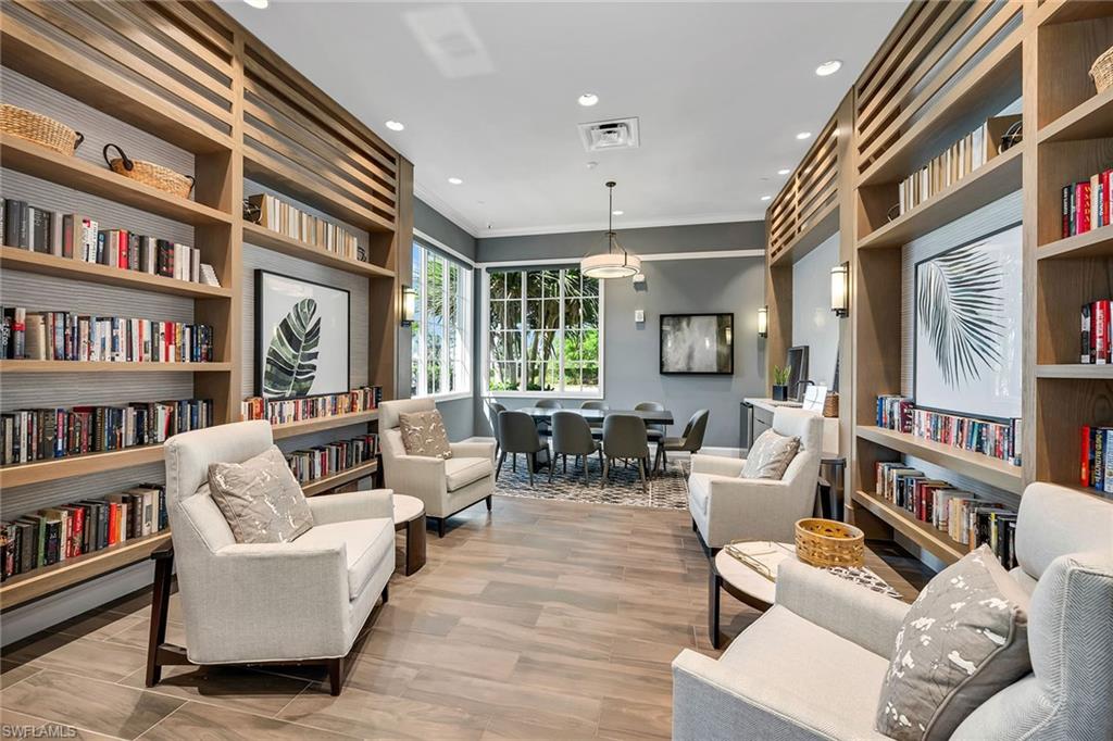 9020 Mayreau Way Naples, FL 34114 - Photo 23 of 28 a living room with fireplace furniture and a book shelf