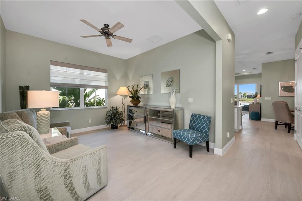 9020 Mayreau Way Naples, FL 34114 - Photo 5 of 28 a living room with furniture and a table with a potted plant