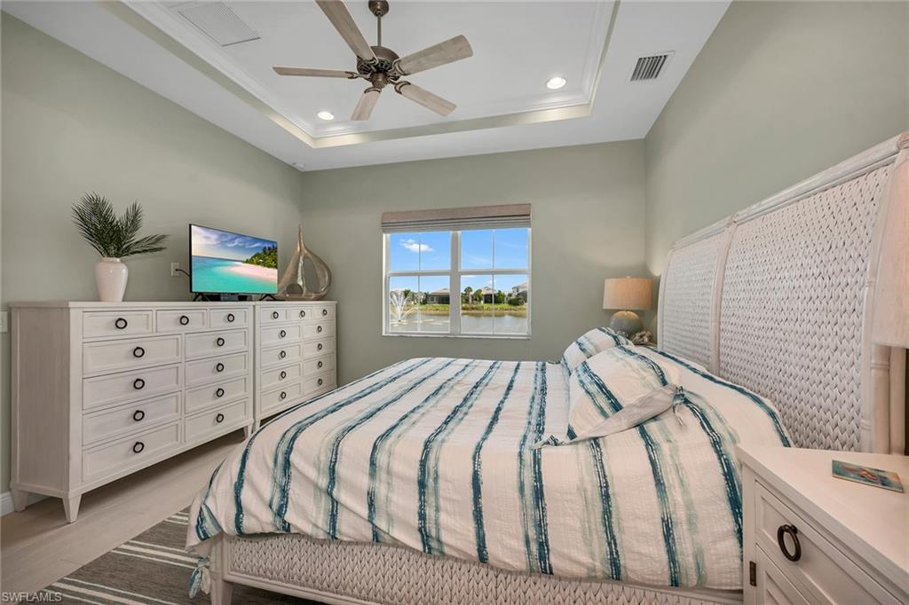 9020 Mayreau Way Naples, FL 34114 - Photo 7 of 28 a bedroom with a bed and a dresser