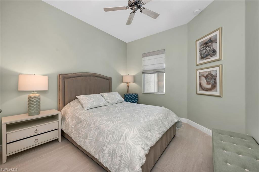 9020 Mayreau Way Naples, FL 34114 - Photo 9 of 28 a bedroom with bed and a chandelier